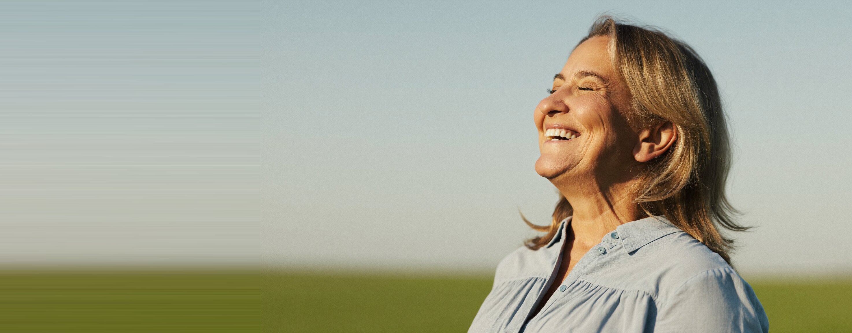 A woman breathing easily and freely through her nose in bright morning light