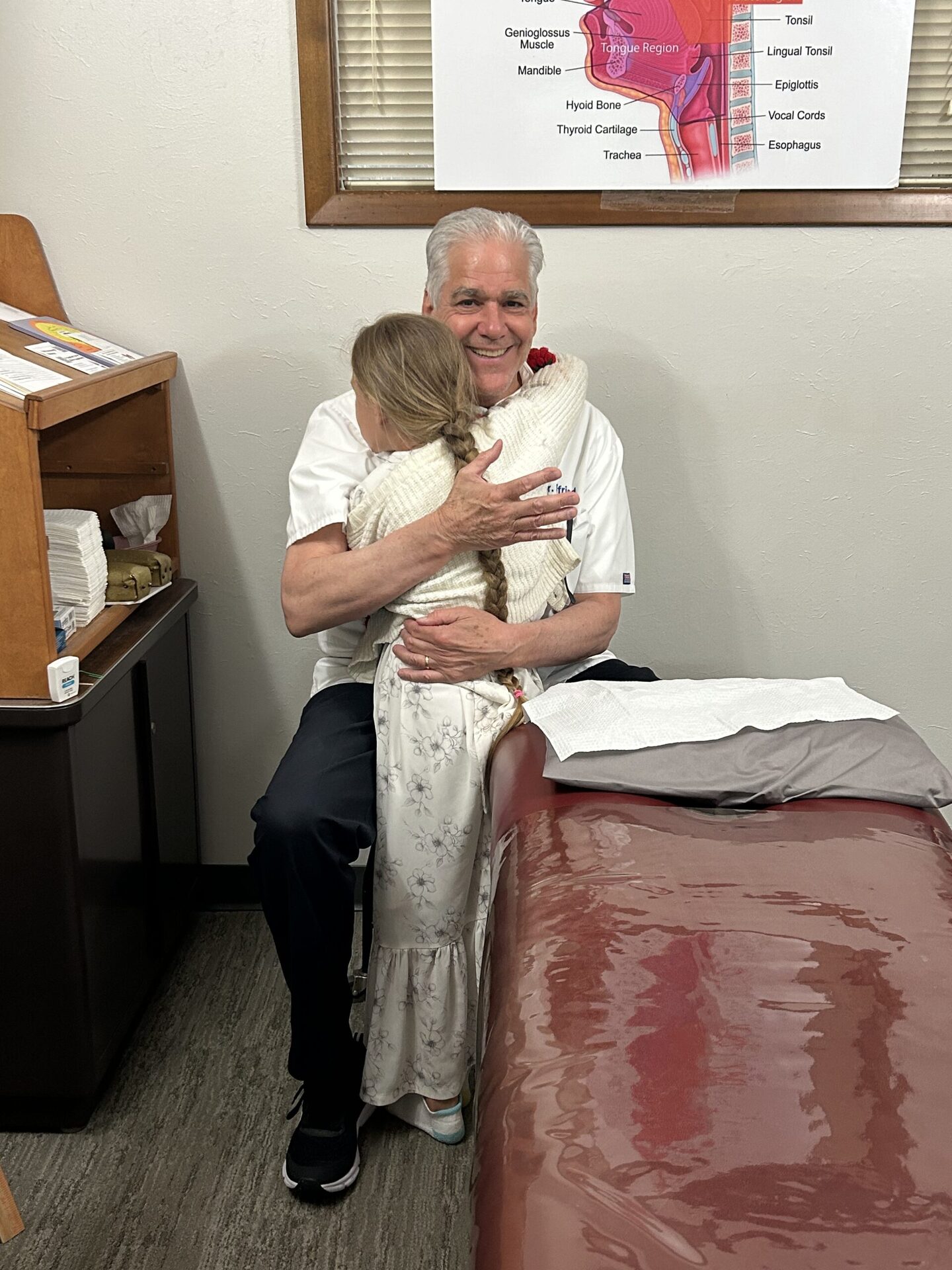 Dr. Siegfried with a young patient in the treatment room at Dunn Chiropractic Clinic